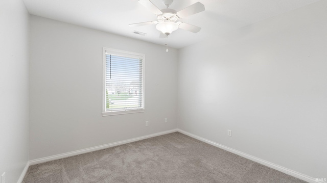 empty room featuring ceiling fan, baseboards, carpet flooring, and visible vents
