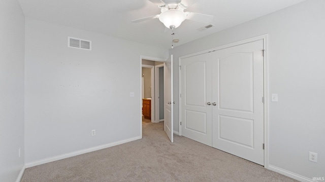 unfurnished bedroom with a closet, visible vents, baseboards, and light carpet