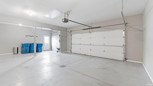 garage with baseboards and a garage door opener