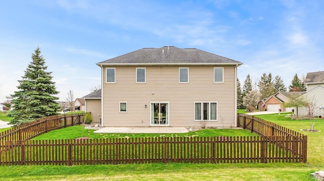 back of house featuring a fenced backyard, a patio, and a lawn