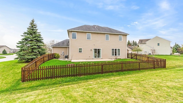 rear view of house featuring a patio area, a fenced backyard, and a yard
