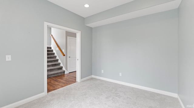 unfurnished room with recessed lighting, carpet floors, baseboards, and stairway