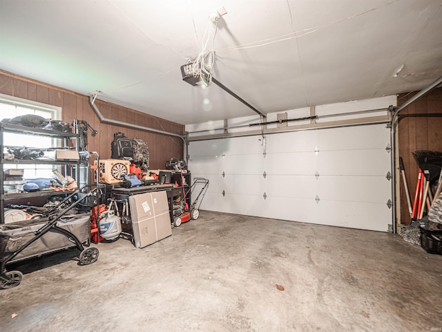 8013 Larch Ln, Evansville, IN 47710 - garage featuring wooden walls and a garage door opener