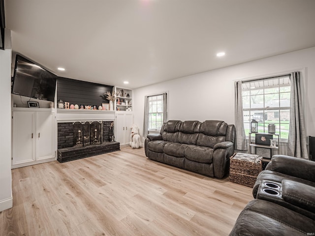 8013 Larch Ln, Evansville, IN 47710 - living room featuring a brick fireplace, wood finished floors, and recessed lighting