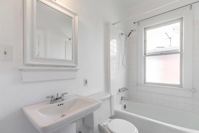 bathroom featuring plenty of natural light, shower / bath combination, toilet, and a sink