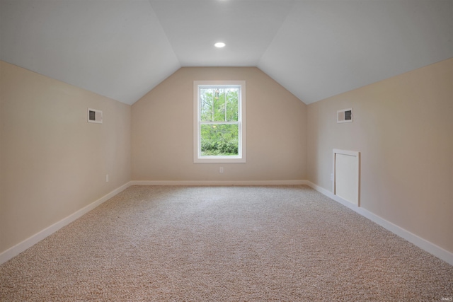 bonus room featuring carpet flooring, baseboards, visible vents, and vaulted ceiling