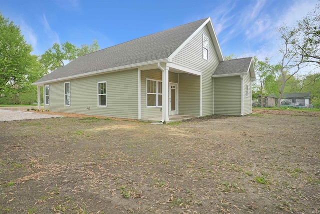 view of side of home featuring a shingled roof