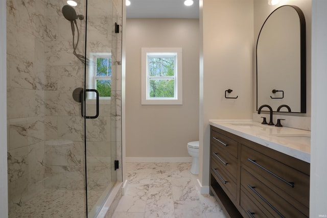 bathroom featuring double vanity, a shower stall, toilet, and a sink