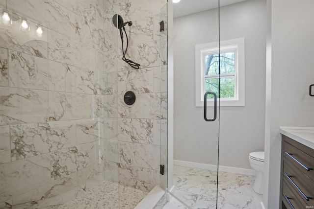 bathroom featuring vanity, a shower stall, and toilet