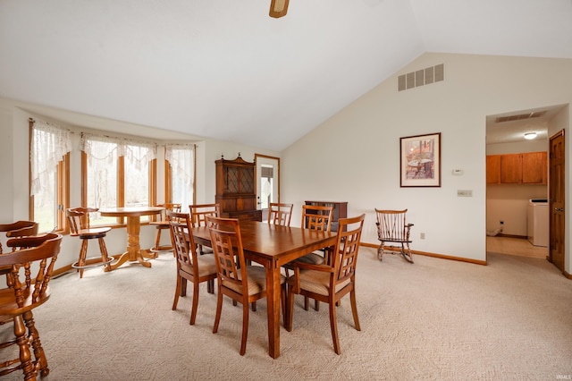 dining space featuring light colored carpet, washer / clothes dryer, visible vents, and plenty of natural light