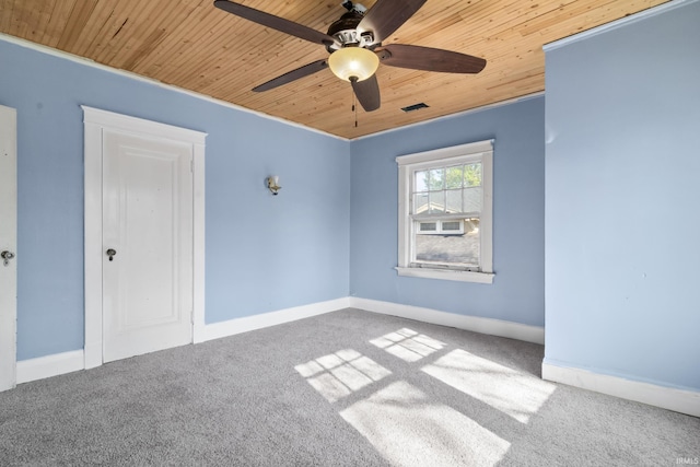 unfurnished bedroom featuring baseboards, carpet, and wood ceiling