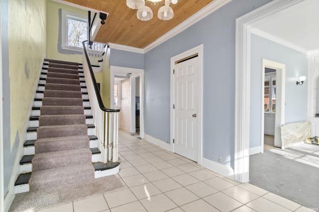 entryway featuring stairway, tile patterned flooring, crown molding, wood ceiling, and a notable chandelier