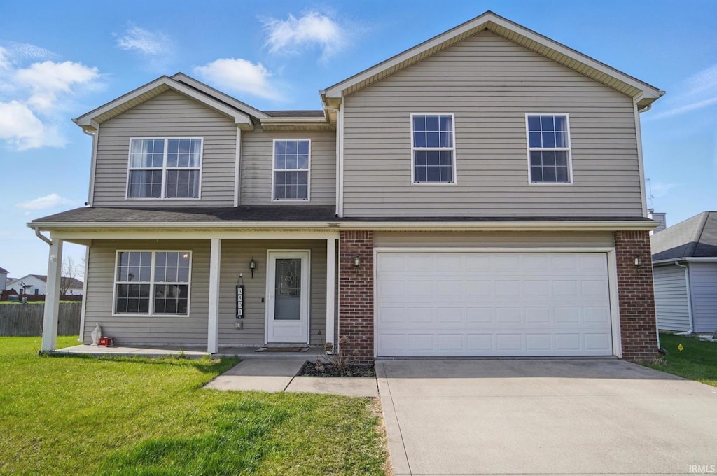 traditional-style home featuring concrete driveway, a porch, brick siding, a front yard, and a garage