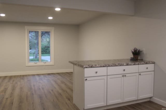 320 W Ritter St, Ellettsville, IN 47429 - interior space featuring recessed lighting, light stone counters, dark wood-type flooring, baseboards, and white cabinetry