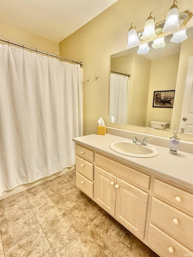 bathroom with tile patterned flooring, vanity, and toilet