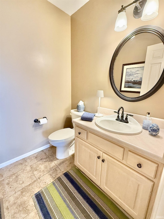 bathroom with tile patterned flooring, baseboards, toilet, and vanity