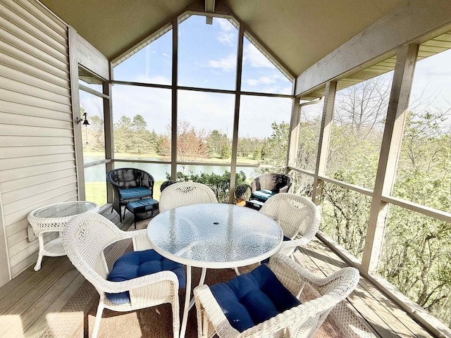 sunroom featuring a wealth of natural light and a water view