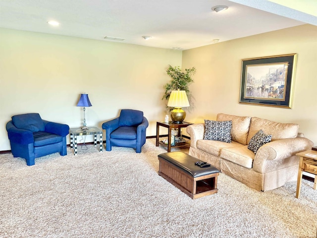living area featuring baseboards, visible vents, and carpet floors