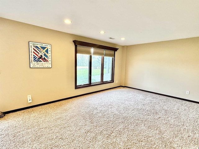 empty room featuring recessed lighting, carpet floors, visible vents, and baseboards