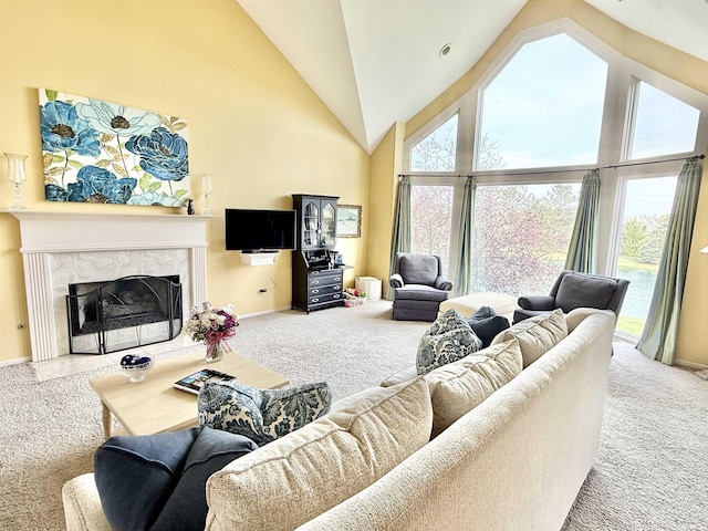 carpeted living area with high vaulted ceiling, a premium fireplace, and plenty of natural light