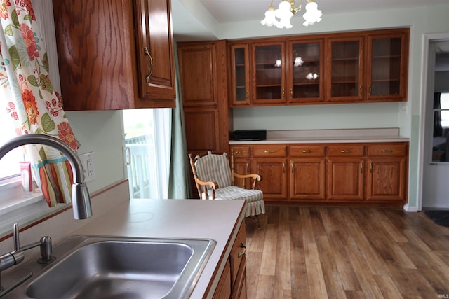 12176 E 350 N, Loogootee, IN 47553 - kitchen with an inviting chandelier, wood finished floors, a sink, and brown cabinets