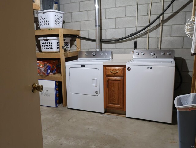 12176 E 350 N, Loogootee, IN 47553 - laundry room featuring washer and dryer, cabinet space, and concrete block wall