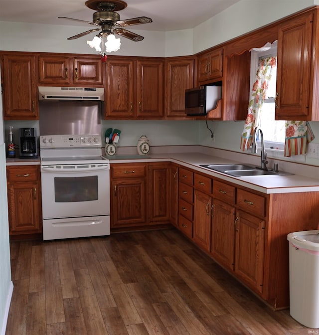 12176 E 350 N, Loogootee, IN 47553 - kitchen featuring white electric range, a sink, brown cabinetry, light countertops, and under cabinet range hood