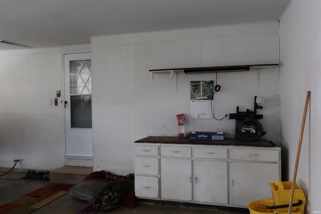12176 E 350 N, Loogootee, IN 47553 - kitchen featuring open shelves, dark countertops, concrete floors, and white cabinets