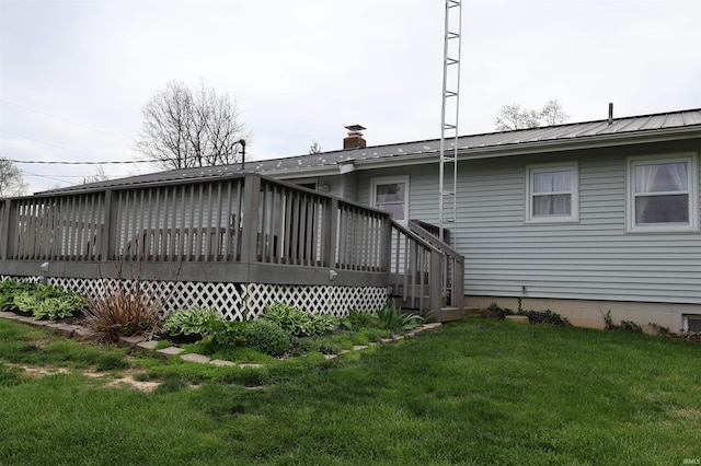 12176 E 350 N, Loogootee, IN 47553 - back of property featuring a lawn, a chimney, a wooden deck, and metal roof