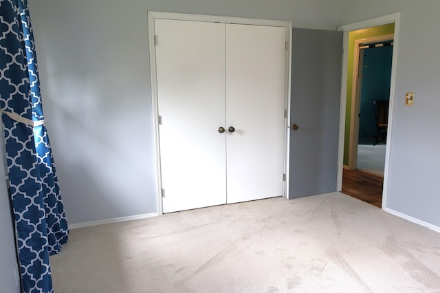 12176 E 350 N, Loogootee, IN 47553 - unfurnished bedroom with baseboards, carpet, and a closet