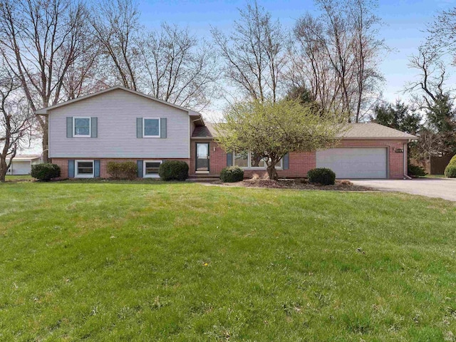 2801 W 700 S, Claypool, IN 46510 - split level home featuring concrete driveway, brick siding, and a garage