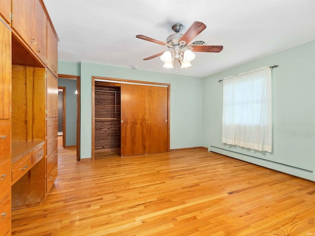 2801 W 700 S, Claypool, IN 46510 - unfurnished bedroom with light wood-type flooring, ceiling fan, a closet, and a baseboard radiator