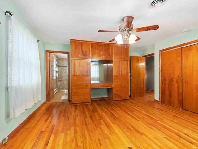 2801 W 700 S, Claypool, IN 46510 - unfurnished bedroom featuring visible vents, light wood-style floors, a closet, ensuite bath, and a baseboard radiator