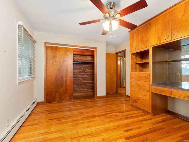 2801 W 700 S, Claypool, IN 46510 - unfurnished bedroom featuring light wood-type flooring, built in desk, a closet, and a baseboard radiator
