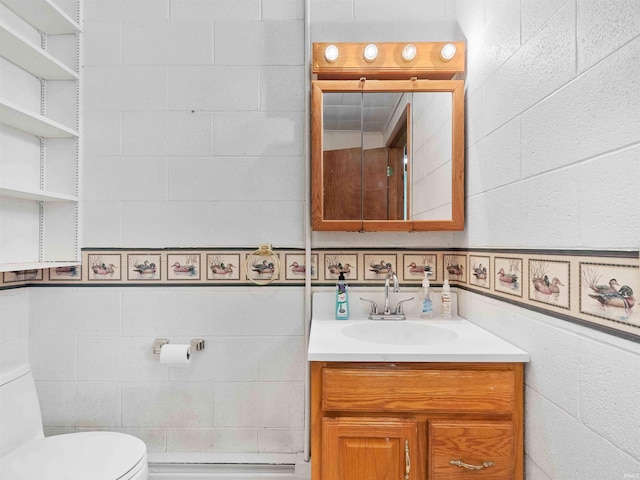 2801 W 700 S, Claypool, IN 46510 - bathroom featuring tile walls, toilet, and vanity