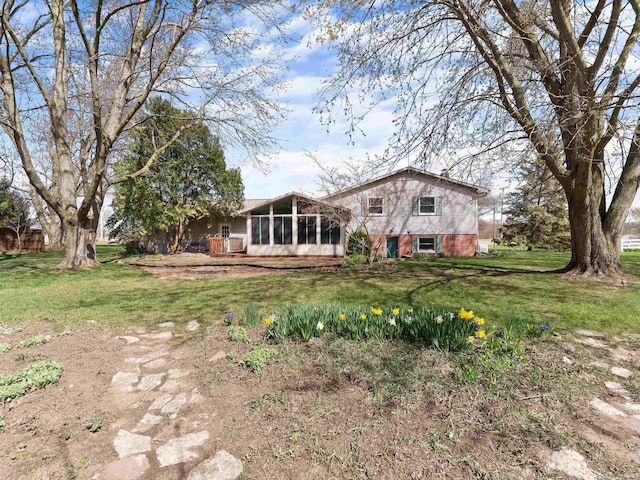 2801 W 700 S, Claypool, IN 46510 - rear view of house with a sunroom and a yard