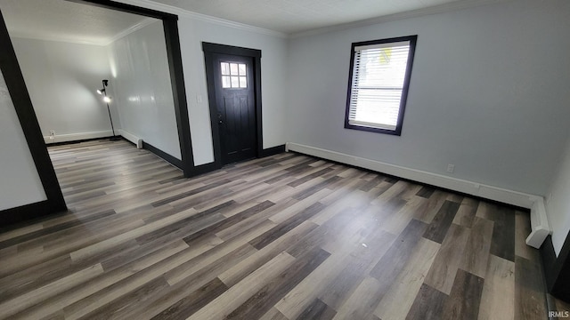 entrance foyer with plenty of natural light, baseboards, wood finished floors, and crown molding