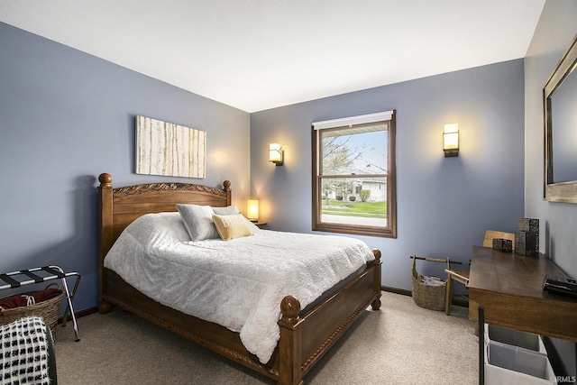 bedroom with baseboards and light colored carpet