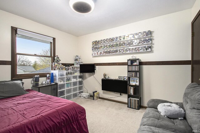 bedroom featuring carpet floors and baseboards