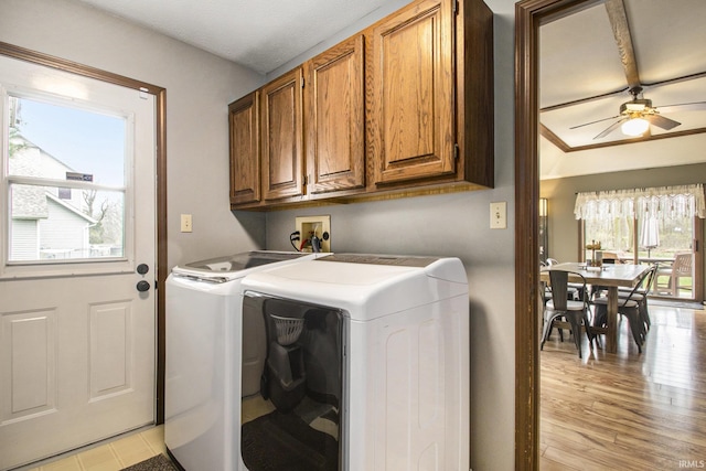 laundry area featuring a ceiling fan, cabinet space, light wood-style floors, and independent washer and dryer