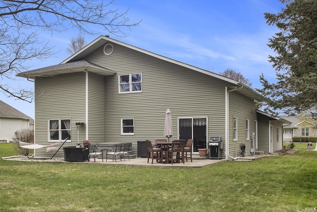 rear view of house with a yard and a patio