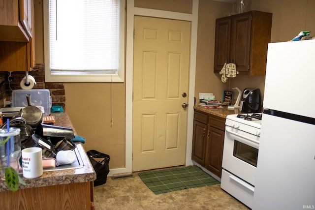 kitchen with decorative backsplash and white appliances