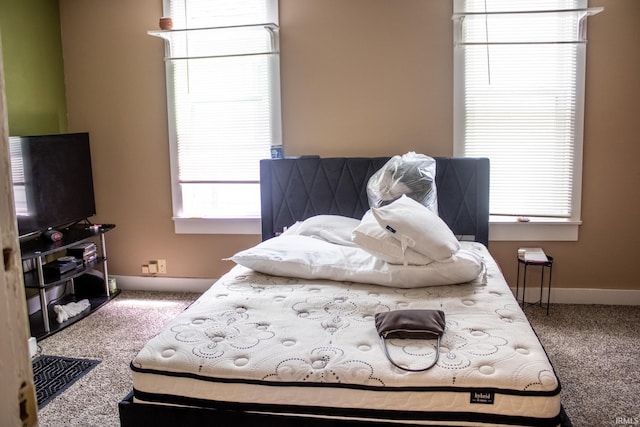 carpeted bedroom featuring baseboards
