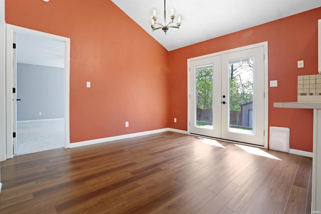 interior space with french doors, wood finished floors, and a chandelier
