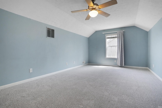 additional living space featuring vaulted ceiling, a ceiling fan, visible vents, and carpet