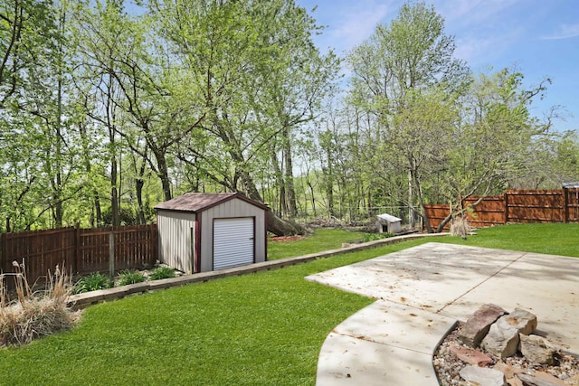 view of yard with a storage unit, a patio area, an outbuilding, and a fenced backyard