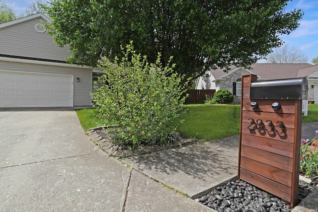 view of front of home featuring a garage, a front yard, and fence