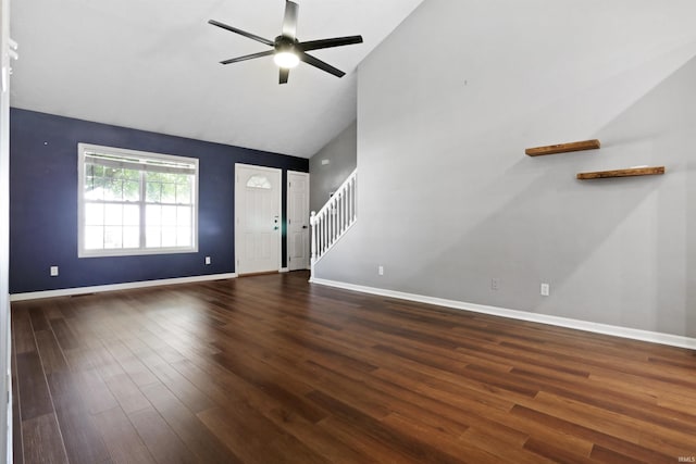 unfurnished living room featuring high vaulted ceiling, a ceiling fan, stairs, dark wood finished floors, and baseboards