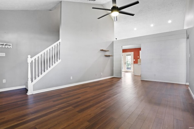 unfurnished living room with a ceiling fan, stairs, baseboards, dark wood-style flooring, and recessed lighting