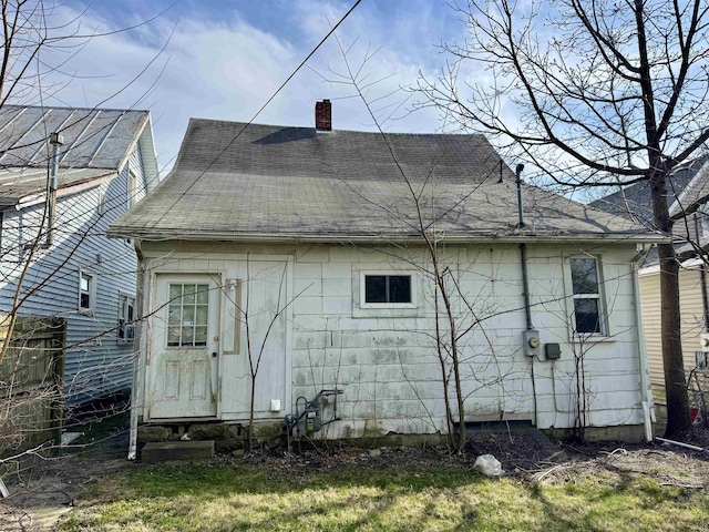 313 E S B St, Gas City, IN 46933 - back of property featuring fence, a chimney, and roof with shingles
